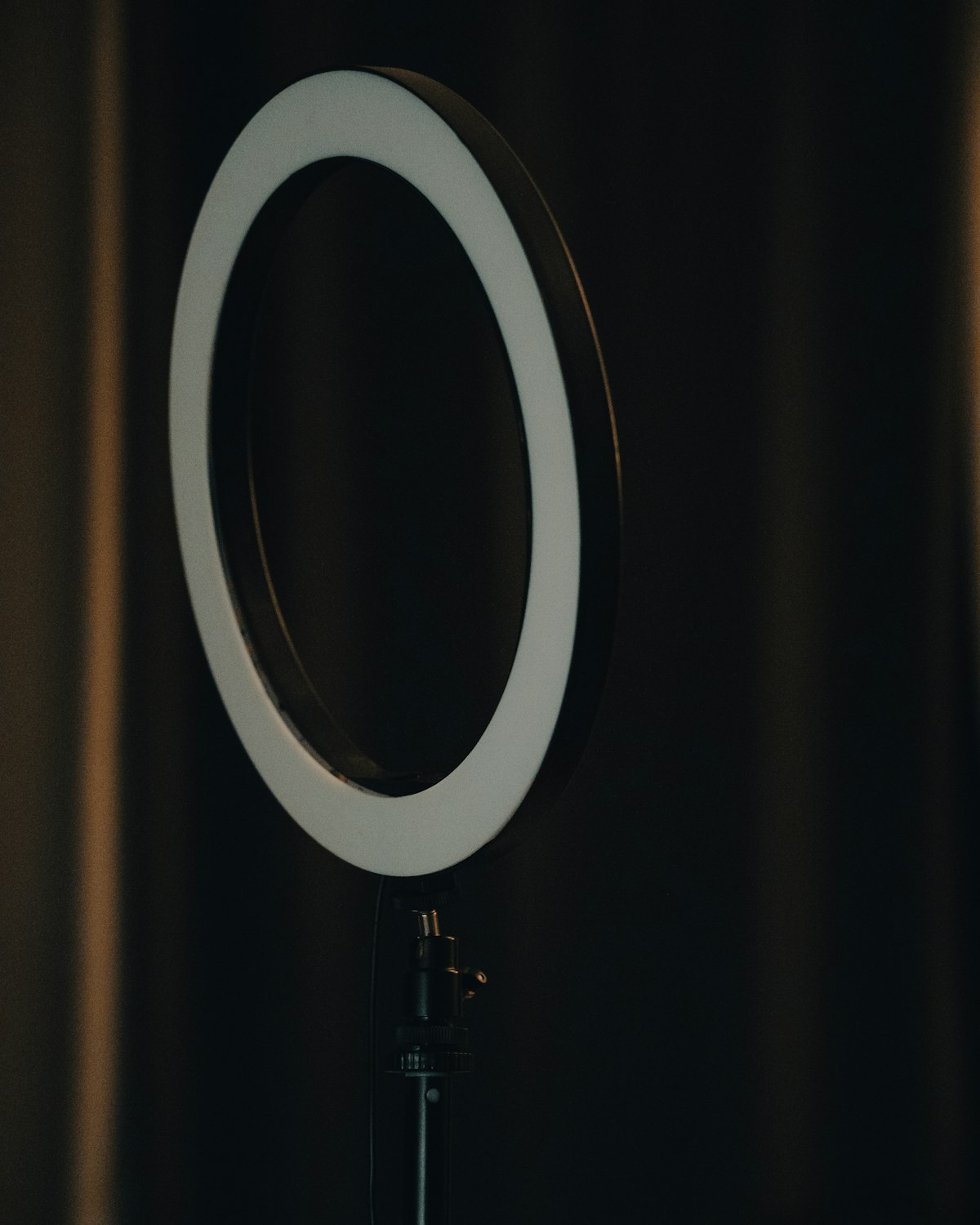 A ring light glowing against a dark studio backdrop.
